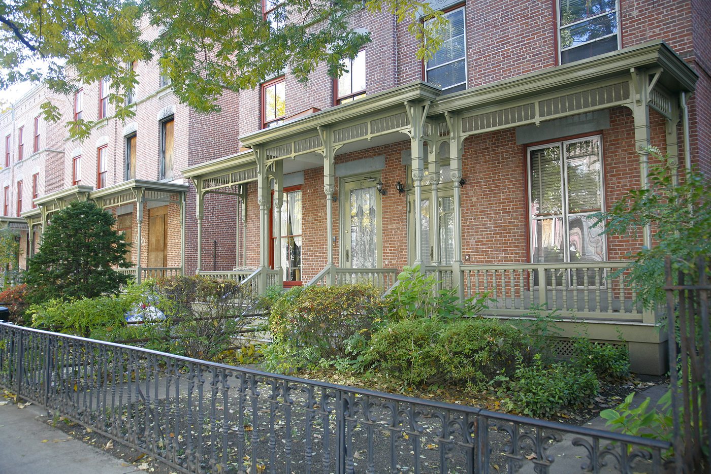 Porches and planted front gardens along Astor Row in Harlem.
