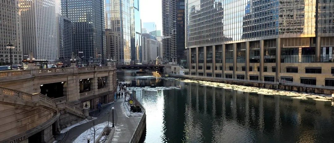 The Chicago Riverwalk beside the river and downtown buildings.