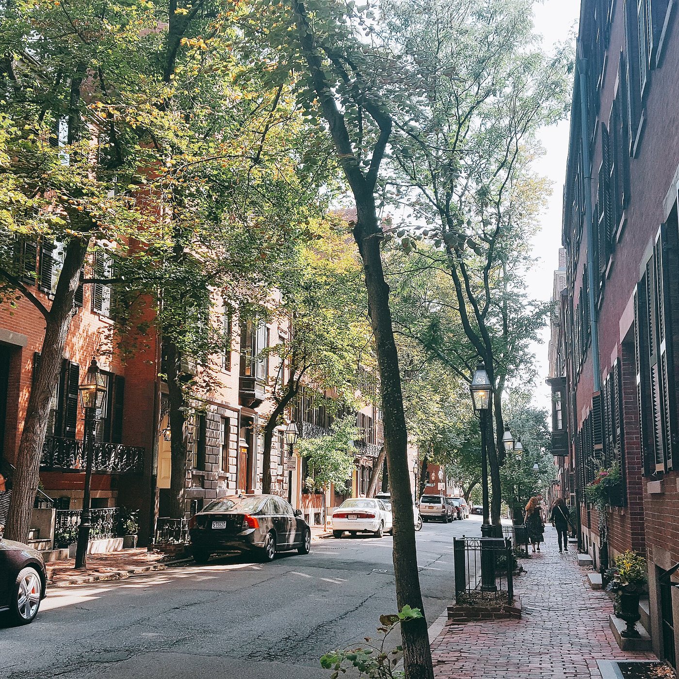The narrow sidewalks and brick buildings of Pinckney Street on Beacon Hill.