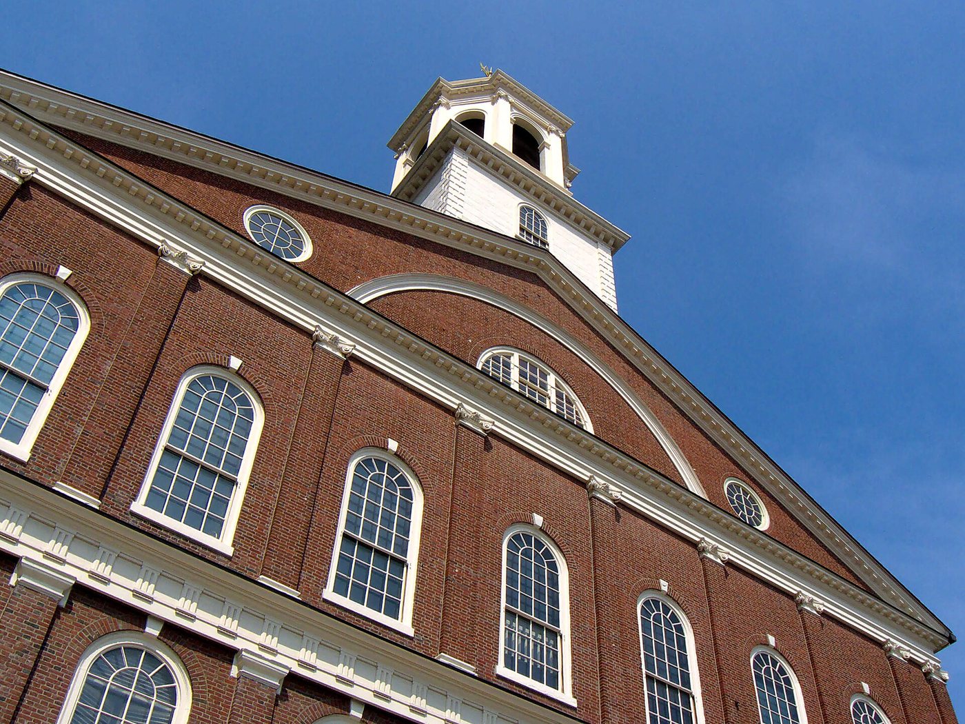 The brick facade and cupola of Faneuil Hall in Boston.