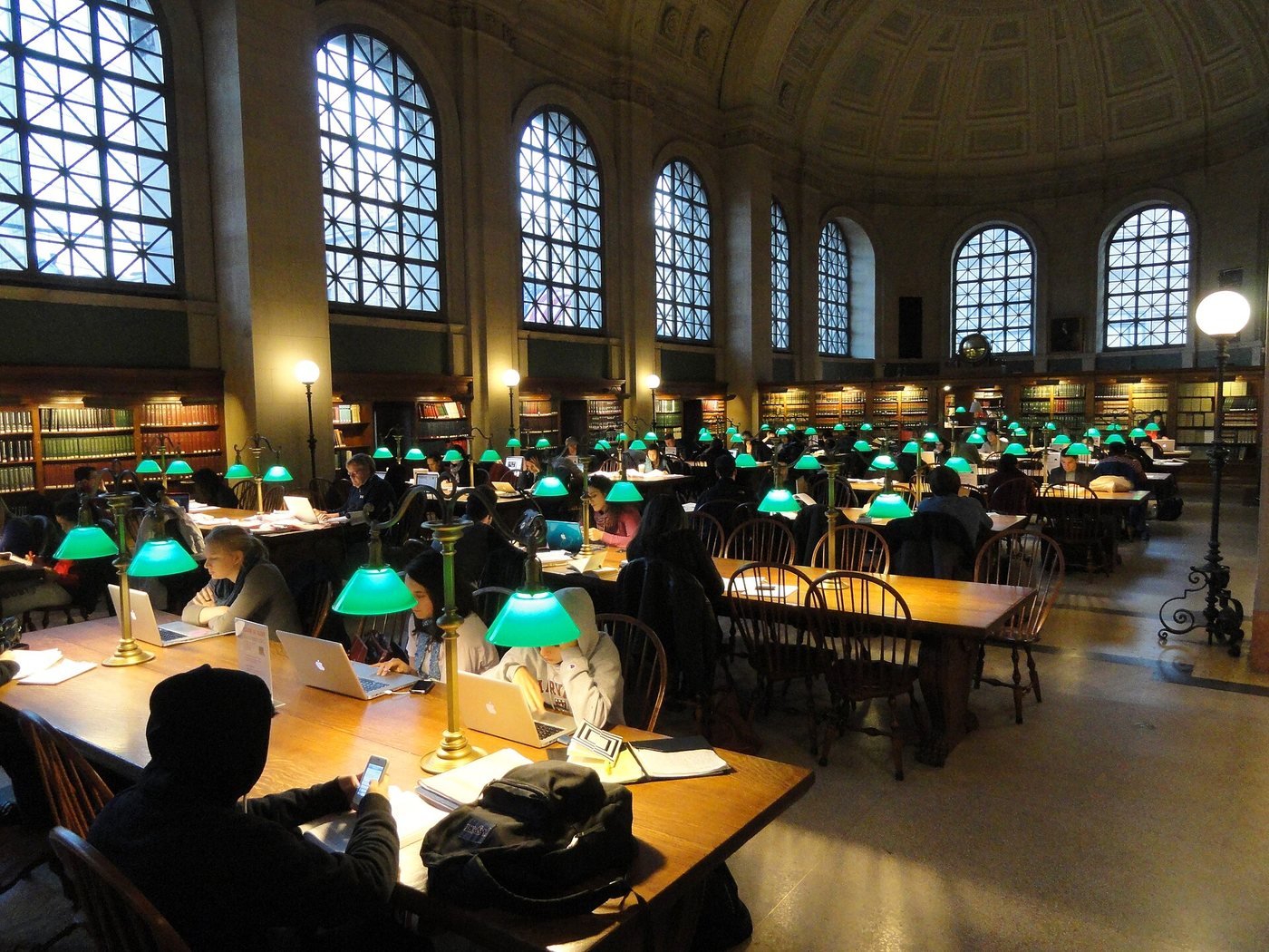 Readers at the long tables inside the Boston Public Library's McKim Building.