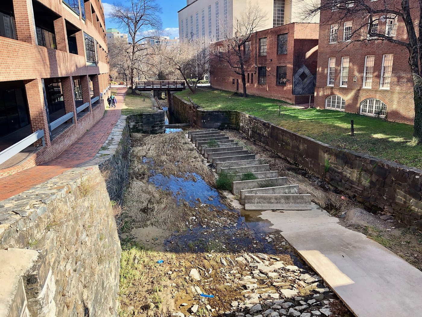 The C&O Canal passing between buildings in Georgetown.