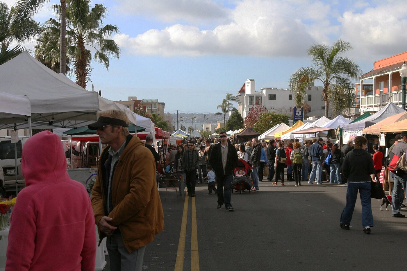 Shoppers and stalls at San Diego's Little Italy Mercato, photographed in 2011.