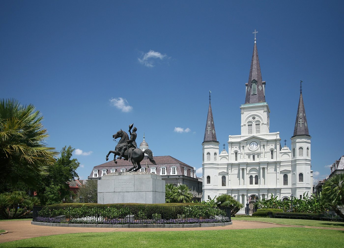 Jackson Square's garden and equestrian monument with St Louis Cathedral behind them.