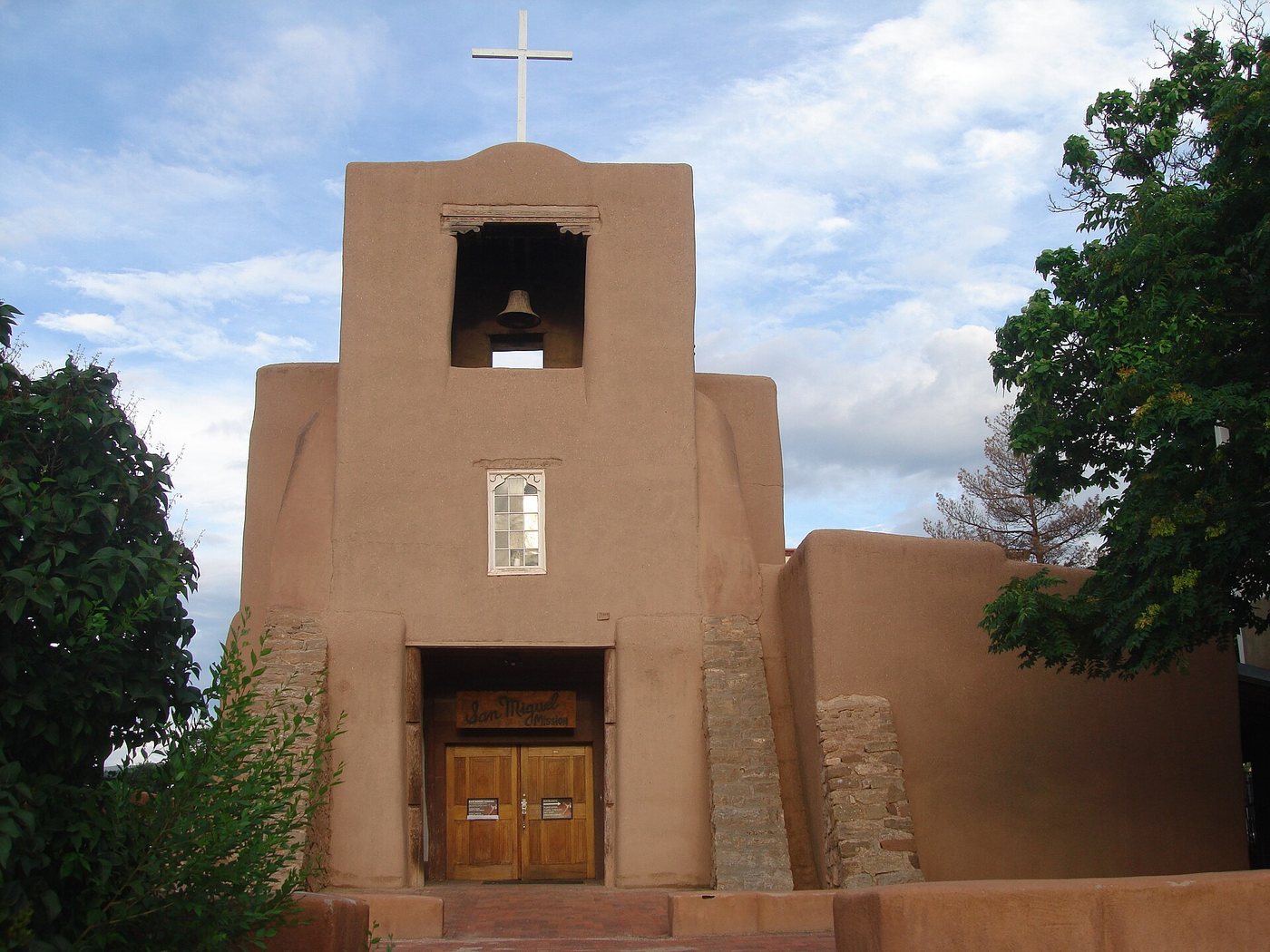 The adobe facade and bell tower of San Miguel Chapel in Santa Fe.