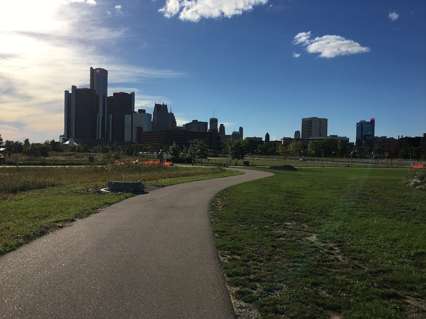 The Detroit Riverwalk path through Milliken State Park with downtown beyond, photographed in 2018.