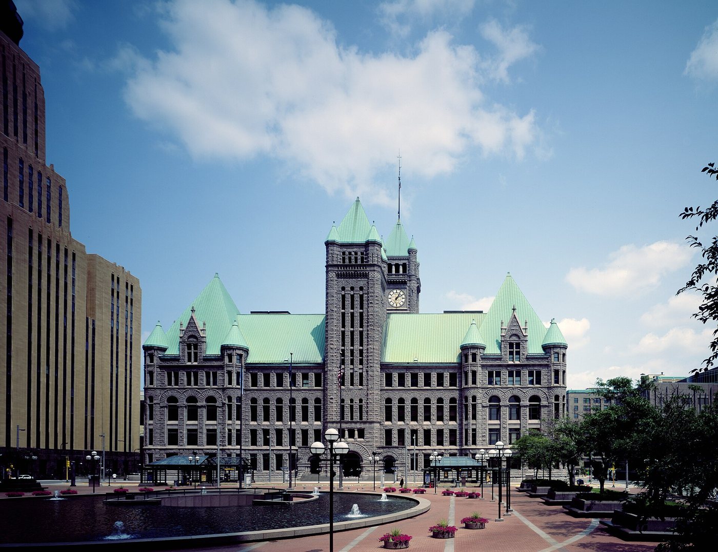 The clock tower and stone facade of Minneapolis City Hall.